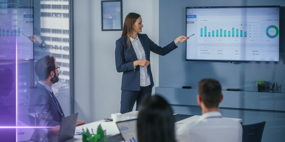 Private equity professional presenting performance charts to stakeholders using a secure data room platform